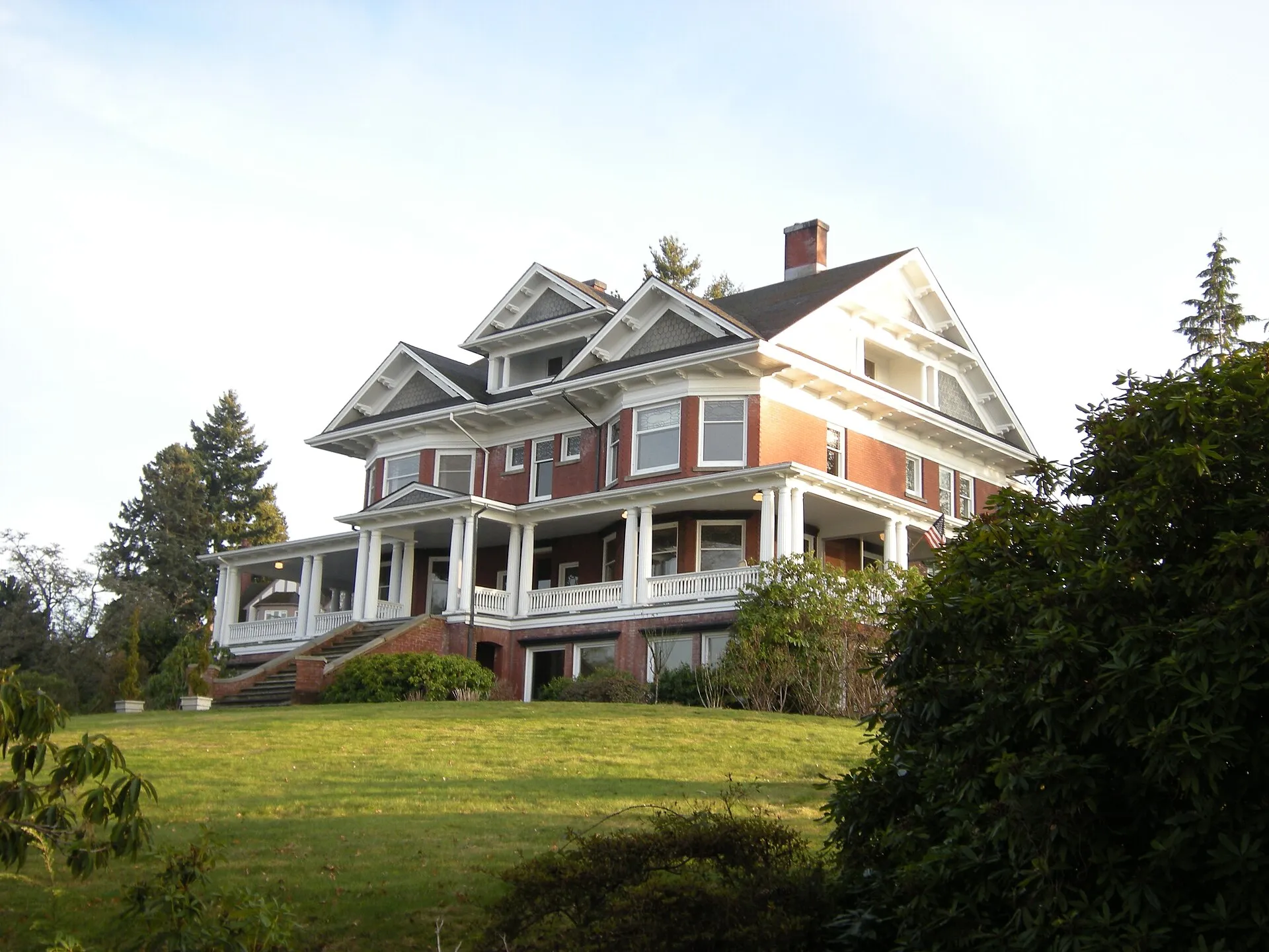The Rucker Mansion, a brick and clapboard house on a grassy hill in Everett